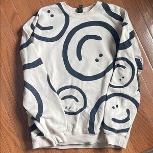 Smiley Face Cream and Black Sweater